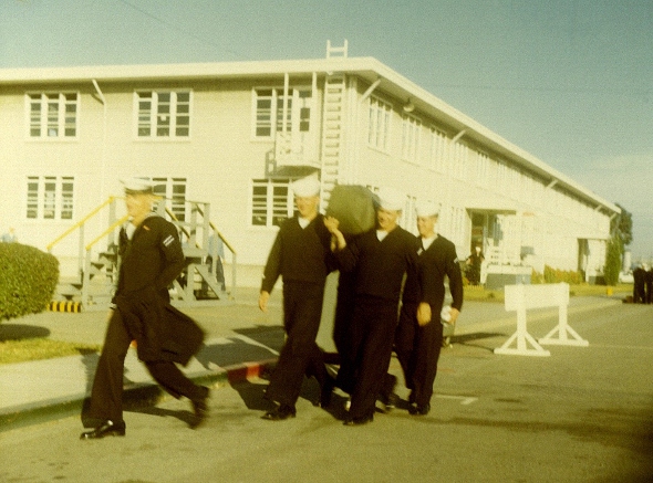 Ron Marlett's friends helping him with his seabag.
